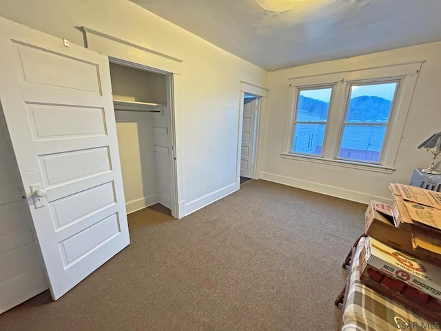 unfurnished bedroom with dark carpet