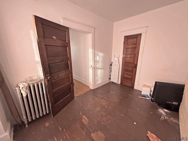 interior space featuring dark hardwood / wood-style flooring and radiator