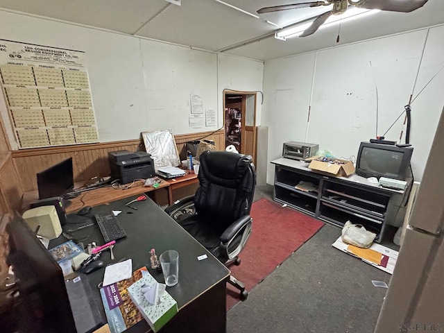 office with ceiling fan and wooden walls