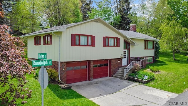 500 Randolph St, Ebensburg, PA 15931 - split foyer home with a garage, a chimney, driveway, a front yard, and brick siding