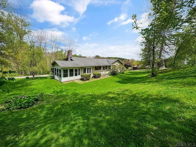 500 Randolph St, Ebensburg, PA 15931 - rear view of house with a sunroom, a lawn, and a chimney