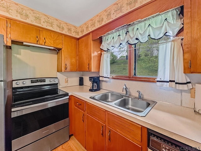 500 Randolph St, Ebensburg, PA 15931 - kitchen with stainless steel range with electric cooktop, a sink, light countertops, brown cabinets, and dishwasher