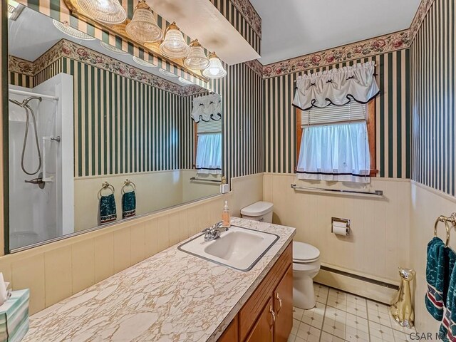 500 Randolph St, Ebensburg, PA 15931 - bathroom featuring a baseboard heating unit, a wainscoted wall, a shower, wallpapered walls, and toilet