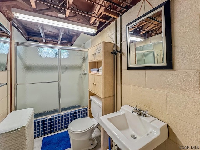 500 Randolph St, Ebensburg, PA 15931 - bathroom featuring a sink, concrete block wall, toilet, and bath / shower combo with glass door