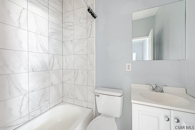 full bathroom with vanity, tiled shower / bath combo, and toilet