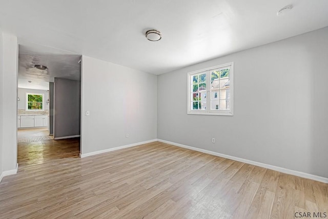 empty room with light hardwood / wood-style flooring