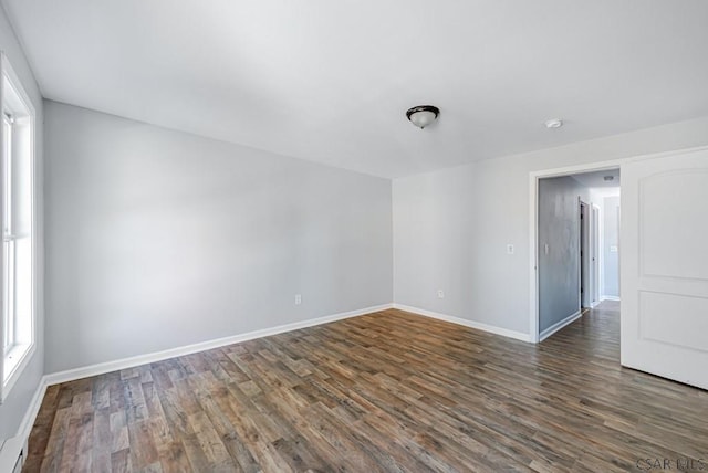 spare room with dark wood-type flooring