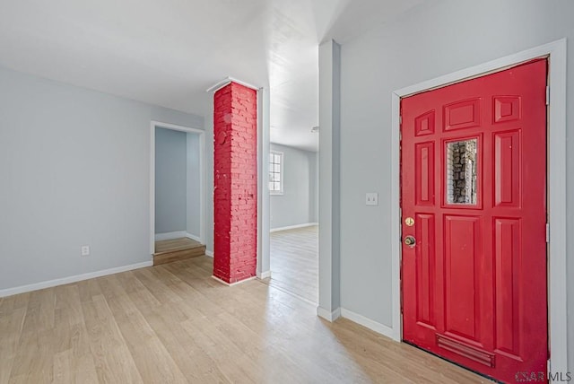 entrance foyer featuring light hardwood / wood-style flooring and decorative columns