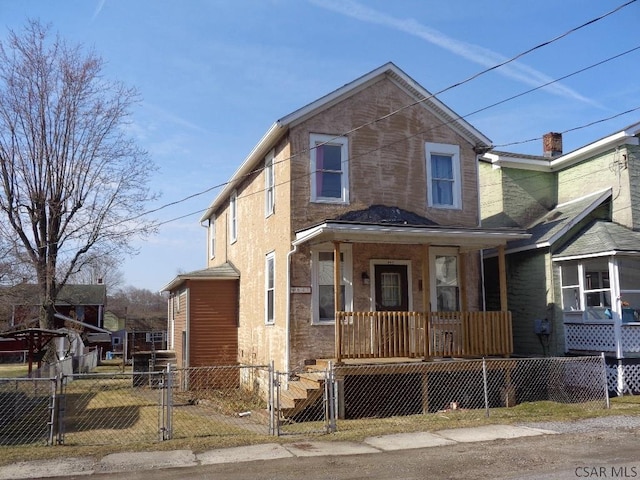 view of front facade featuring a fenced front yard, a porch, and a gate