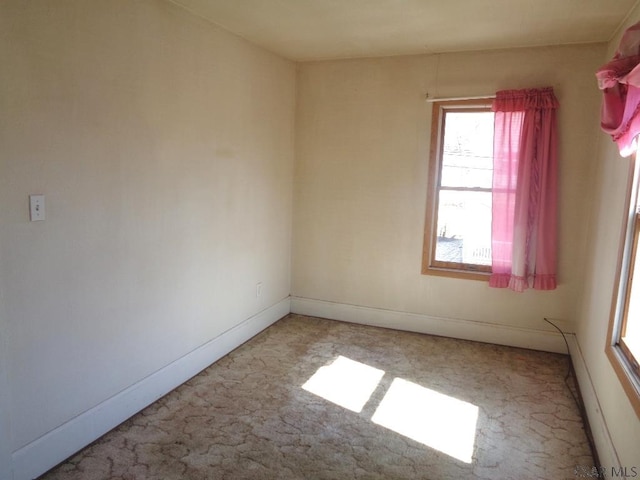 unfurnished room featuring baseboards and carpet floors