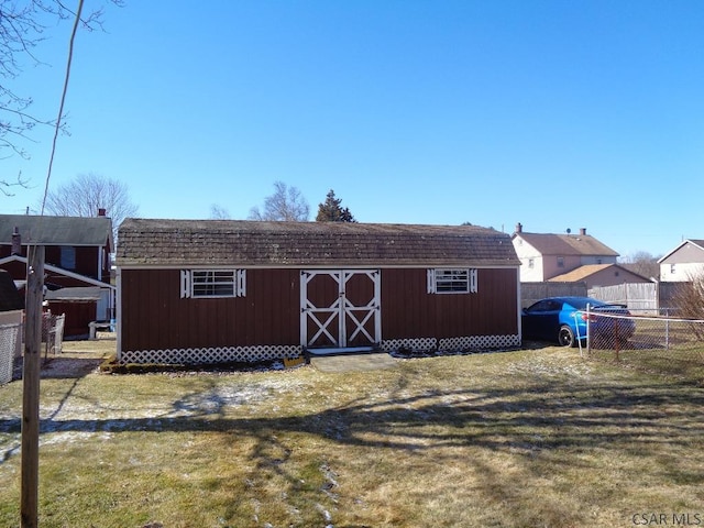 view of shed featuring fence