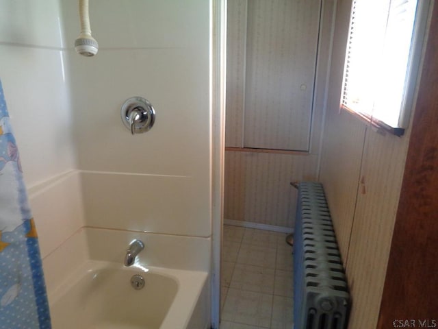 bathroom with radiator heating unit and shower / bathtub combination with curtain