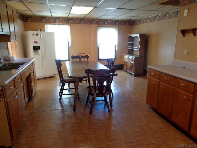 dining area featuring a drop ceiling