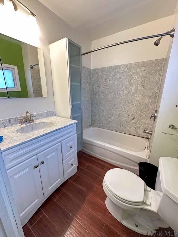 full bathroom with shower / tub combination, vanity, and toilet