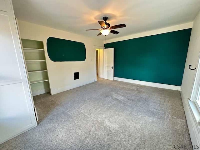 unfurnished bedroom featuring ceiling fan, light colored carpet, and a closet