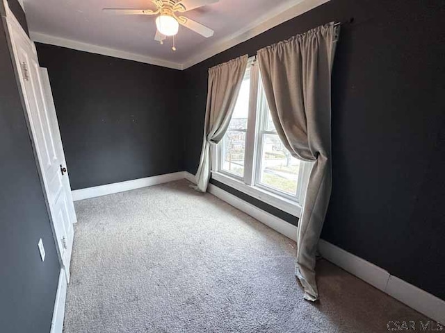 carpeted spare room with ceiling fan