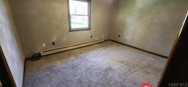unfurnished room with baseboards, a baseboard heating unit, and carpet