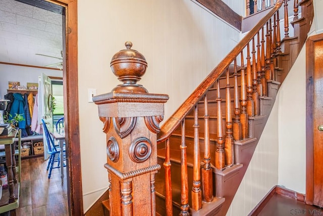 stairway featuring baseboards and wood finished floors