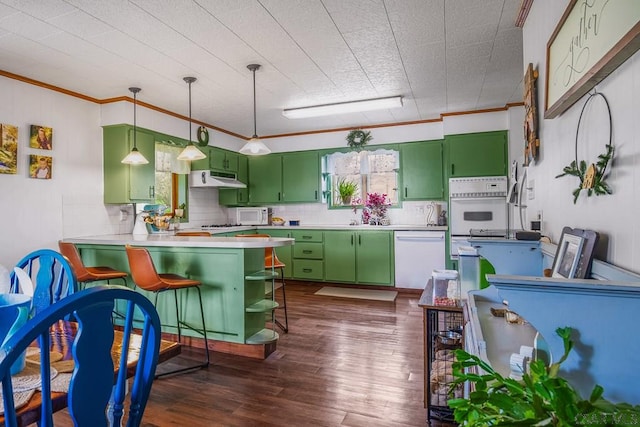 kitchen with tasteful backsplash, white appliances, under cabinet range hood, crown molding, and green cabinets