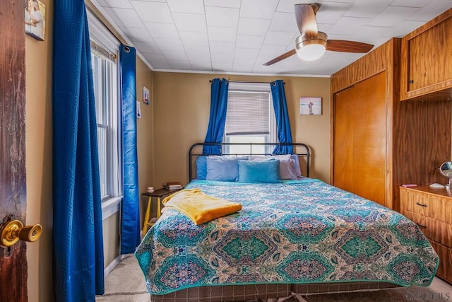 carpeted bedroom with a ceiling fan