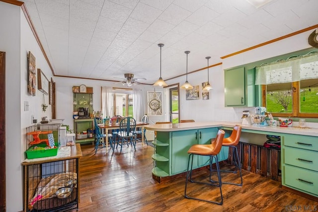 kitchen featuring ornamental molding, a peninsula, open shelves, ceiling fan, and green cabinetry