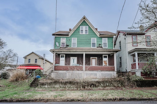 view of front of home with covered porch and a chimney