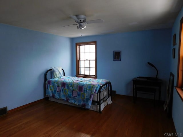 bedroom with dark wood-type flooring and ceiling fan