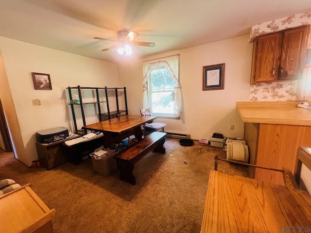 home office with baseboard heating, ceiling fan, and carpet