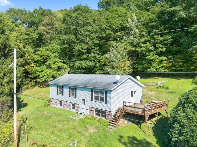 rear view of property with a yard and a deck