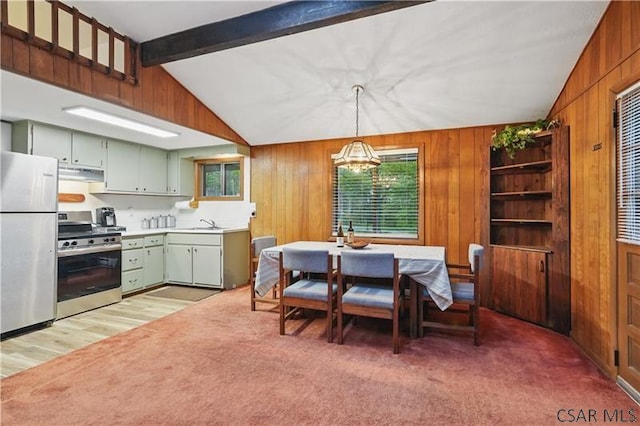 112 Ottawa Ln, Central City, PA 15926 - dining area with wood walls, a chandelier, and light carpet