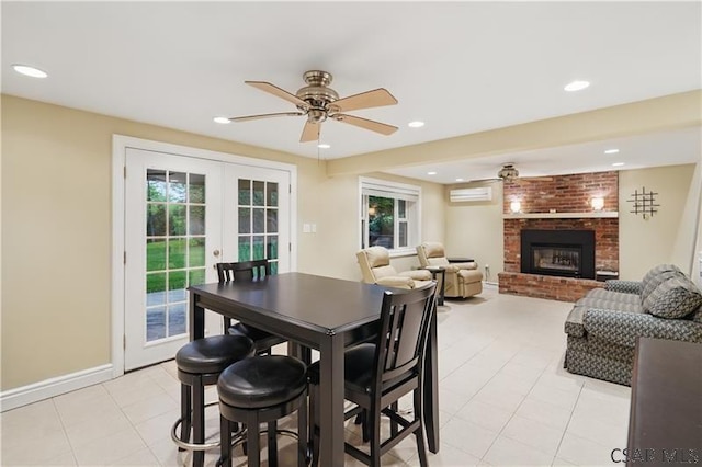 112 Ottawa Ln, Central City, PA 15926 - dining space featuring a wall unit AC, ceiling fan, french doors, a fireplace, and recessed lighting