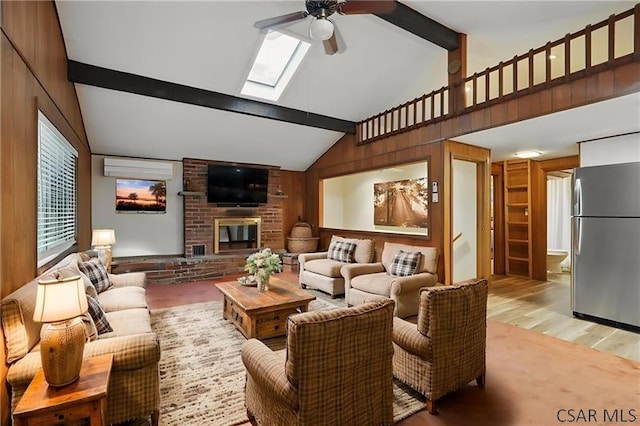 112 Ottawa Ln, Central City, PA 15926 - living room featuring a ceiling fan, a skylight, light wood-style floors, a brick fireplace, and wood walls