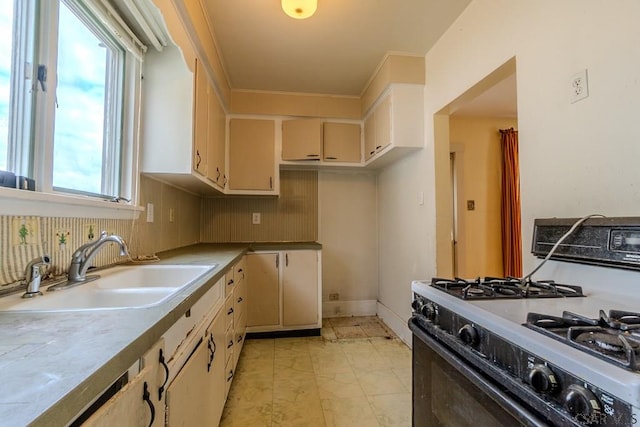 1461 Franklin St, Johnstown, PA 15905 - kitchen with range with gas stovetop, a sink, tasteful backsplash, light countertops, and cream cabinetry
