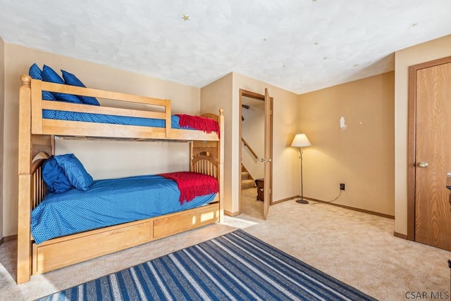 carpeted bedroom featuring baseboards