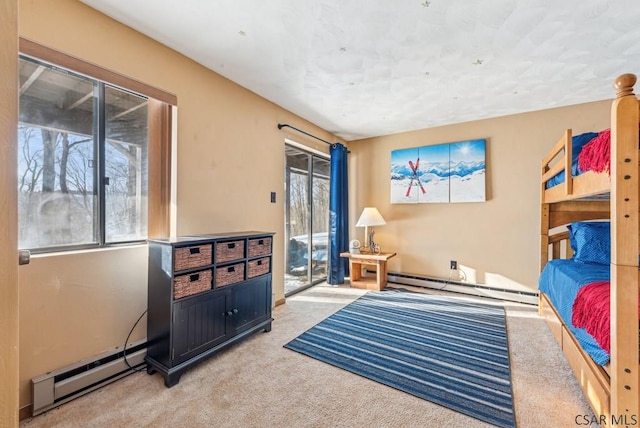 bedroom featuring a baseboard heating unit, access to exterior, and light colored carpet