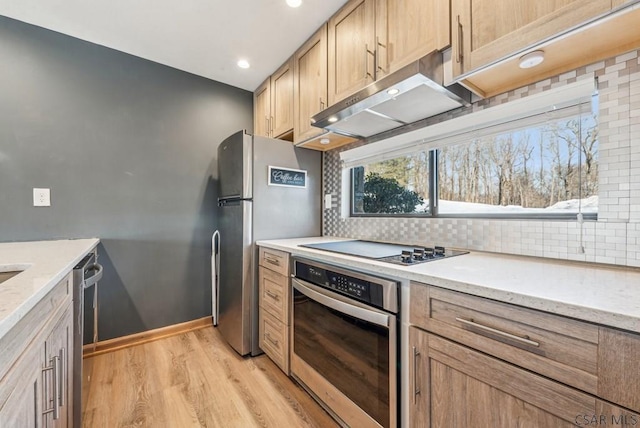 kitchen with stainless steel appliances, backsplash, light wood-style floors, and under cabinet range hood