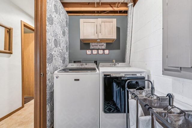 laundry area with concrete block wall, electric panel, cabinet space, and washer and clothes dryer