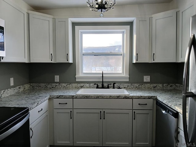 kitchen featuring white cabinetry, sink, and appliances with stainless steel finishes