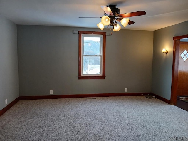 carpeted empty room featuring ceiling fan