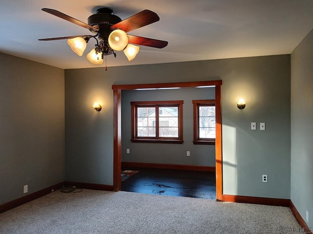 carpeted spare room featuring ceiling fan