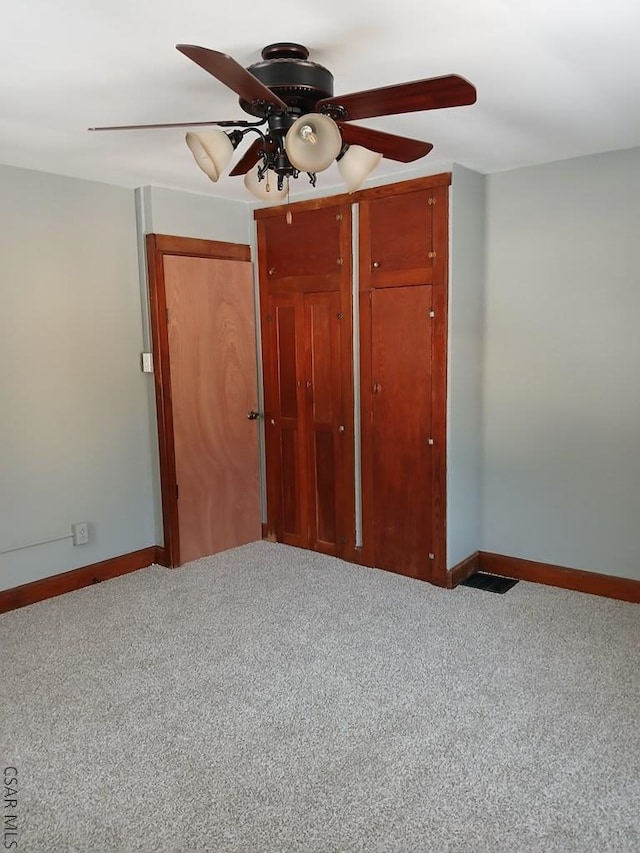 unfurnished bedroom with light carpet and ceiling fan