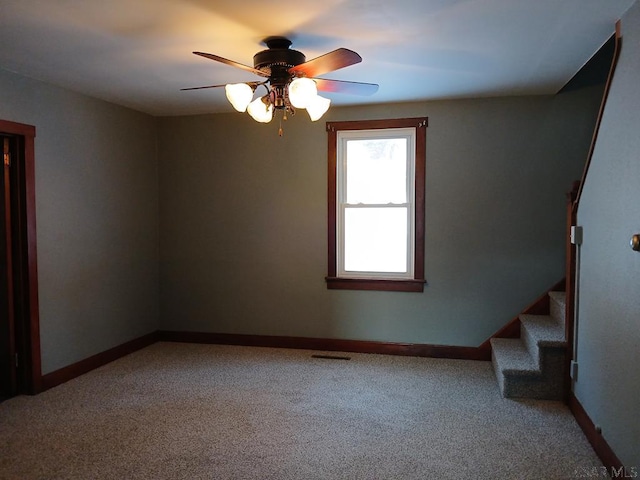 empty room with carpet floors and ceiling fan