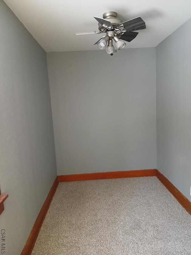 spare room with carpet and ceiling fan