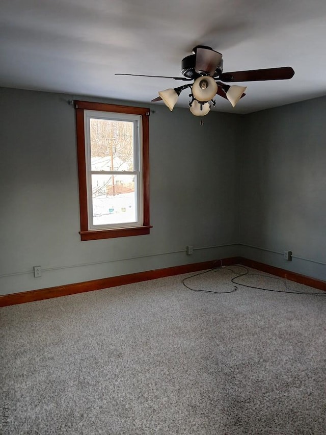 carpeted empty room featuring ceiling fan