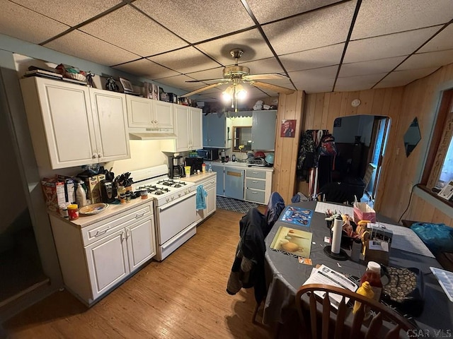 190 Beatty Ave, Johnstown, PA 15906 - kitchen featuring gas range gas stove, a drop ceiling, ceiling fan, light countertops, and wood walls