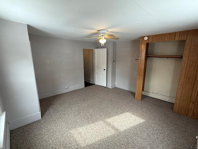 unfurnished bedroom featuring baseboards, dark carpet, and ceiling fan