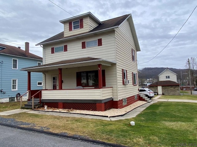 view of front of house with cooling unit, a garage, covered porch, and a front yard