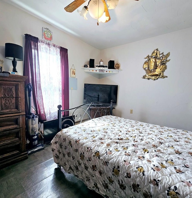 bedroom featuring ceiling fan and dark wood-style flooring