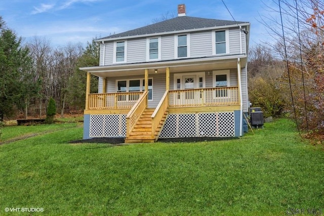 view of front of house featuring cooling unit, a front yard, and a porch