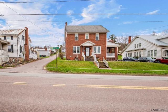 view of front of house with brick siding and a front yard